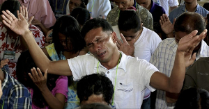 Christian man prays for the men stoning him