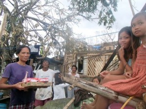 Carlota Ursaig, 45-years-old, was thankful to be reunited with her 6 children after a tree landed on the house they had been taking shelter in. They gladly received food that an OM team had to spare. (Image, caption courtesy OM)