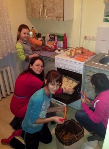 Peeling, dicing, cutting and baking. Wonderful team work! (Image, caption courtesy Orphan Outreach)