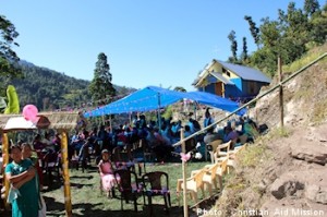 Dozens of villagers and ministry guests turned out for the dedication of the new church in November 2013.  (Image, caption courtesy Christian Aid)
