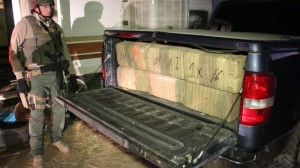 This ICE photo pictures a federal agent with drugs in the back of a truck. It was released in conjunction with Operation Pipeline Express. Operation Pipeline Express was an action carried out by Homeland Security Investigations. (Photo, caption courtesy Wikimedia Commons)