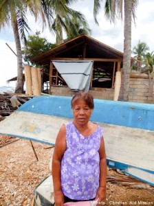 Persita stands in front of her new home that was reconstructed by members of several local churches. (Image, caption courtesy Christian Aid)