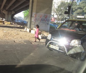 Little girl walks alone in the busy streets of Mumbai.  (Photo courtesy Katey Hearth)