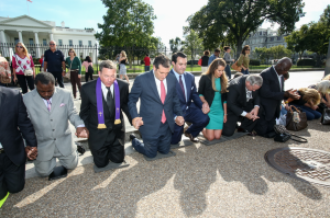U.S. Sen. Ted Cruz of Texas (center, red tie) and ACLJ Executive Director Jordan Sekulow (right of Cruz) kneel in prayer outside of the White House on Sept. 26, 2013. Cruz and other national political and faith leaders joined with the ACLJ in calling for Pastor Saeed Abedini's release at prayer vigils marking the one-year anniversary of the pastor's imprisonment in Iran. (Photo courtesy of The American Center for Law and Justice)