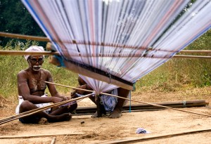 A weaver in India prepares his thread.  (Photo courtesy Wikipedia)