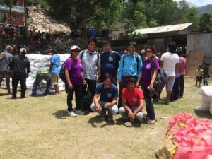 International Needs Nepal Team in village distributing food. 