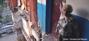 An apartment dweller in a bombed-out building in Ukraine.  (Photo, caption courtesy Christian Aid Mission)