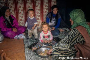 A family shares an afternoon meal of peanuts in a makeshift refugee camp in Adana, Turkey. (Photo courtesy Christian Aid Mission) 