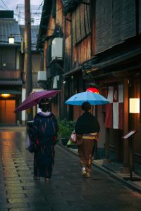 Women in traditional outfits and umbrellas walking together in Kyoto, Japan. (Photo, caption courtesy of Ryutaro Tsukata/Pexels)