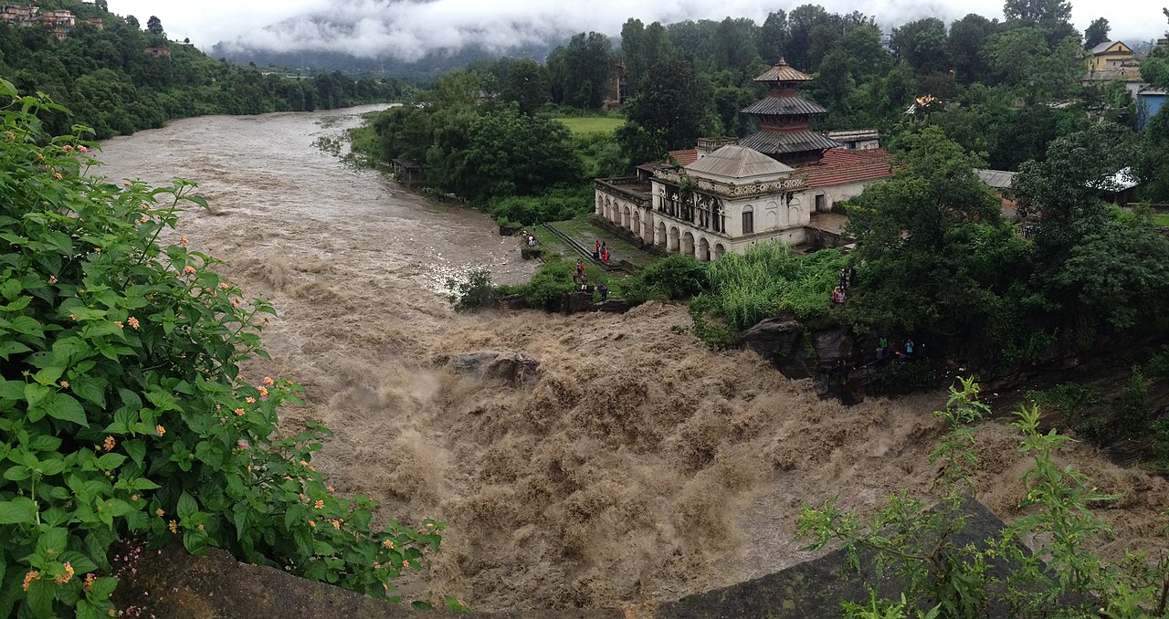 The Bagmati River, considered holy by both Hindus and Buddhists, runs through the Kathmandu valley of Nepal before joing the Koshi River in the Indian state of Bihar. The header image shows the river in flood stage during the 2016 summer monsoon season. (Wikimedia Commons)