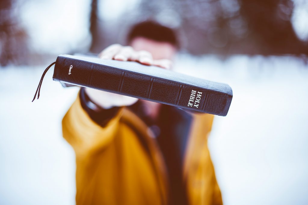 stock, face hidden, Bible, 2Feb2024, man, yellow jacket
