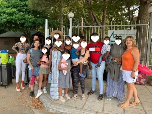 Women gather together in front of Damaris House.