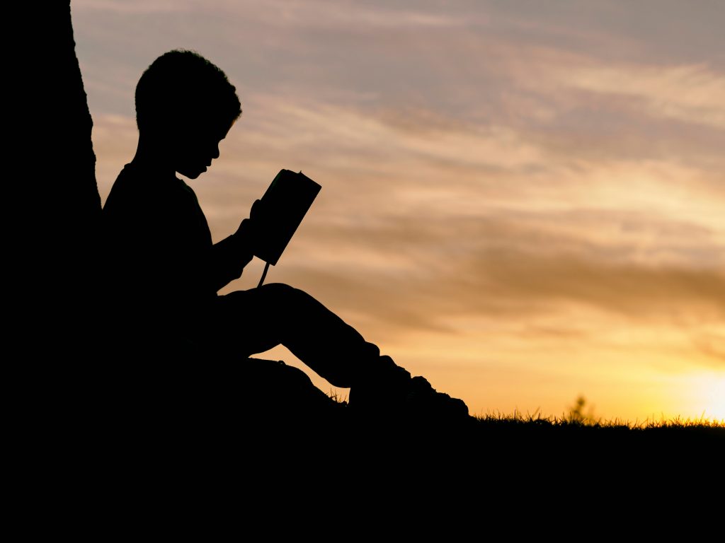 Photo by Aaron Burden on Unsplash https://unsplash.com/photos/silhouette-of-child-sitting-behind-tree-during-sunset-6jYoil2GhVk