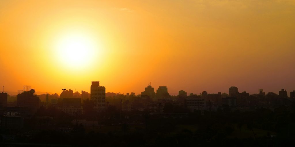 https://unsplash.com/photos/the-sun-is-setting-over-a-city-with-tall-buildings-Oh6ZTXzPKe0