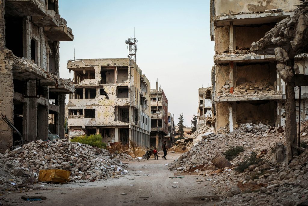 people walk in ruins