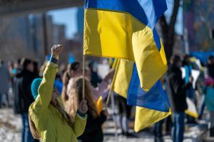 Person holding Ukrainian flag in crowd